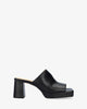 Heeled mules with platform in black leather