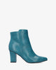 Heeled booties in blue faux leather.
