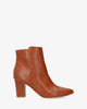 Heeled booties in brown faux leather.
