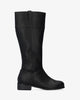 Flat high-calf boots in black faux leather.