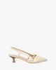Slingback beige patent shoes with a kitten heel