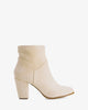 Heeled booties in off-white faux suede