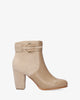 High heeled combined beige colour bootie.