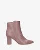 Heeled booties in mauve faux leather.