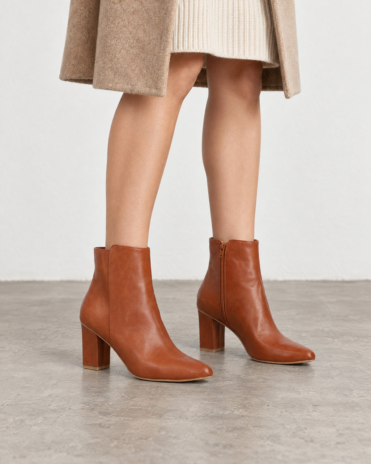 Heeled booties in brown faux leather.