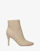 High-heeled booties in ivory faux leather