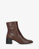 Heeled booties in brown leather