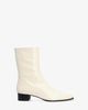 Heeled booties in off-white leather