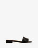 Flat sandals in black leather